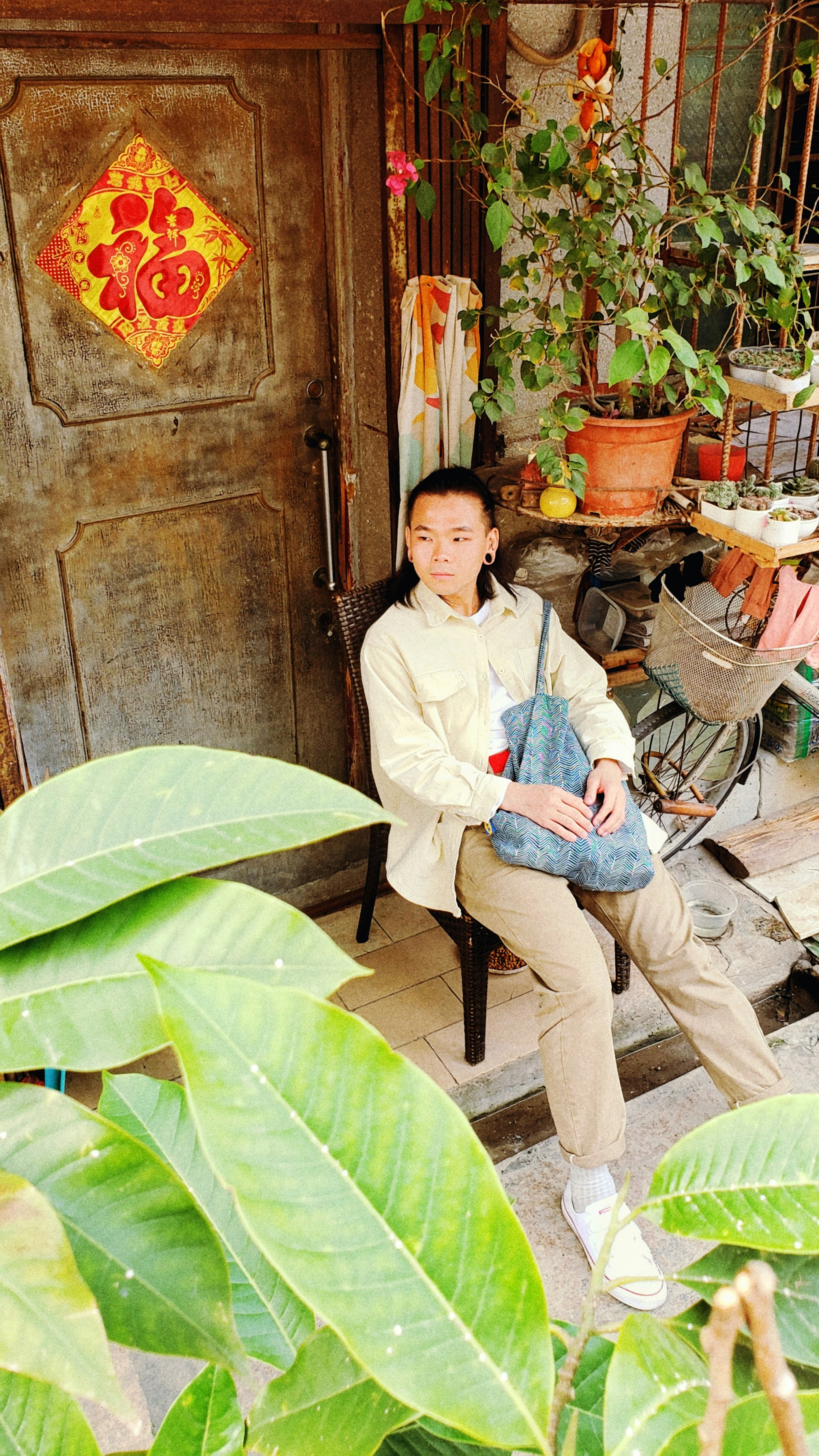 woman wearing brown pants sitting on brown wooden chair